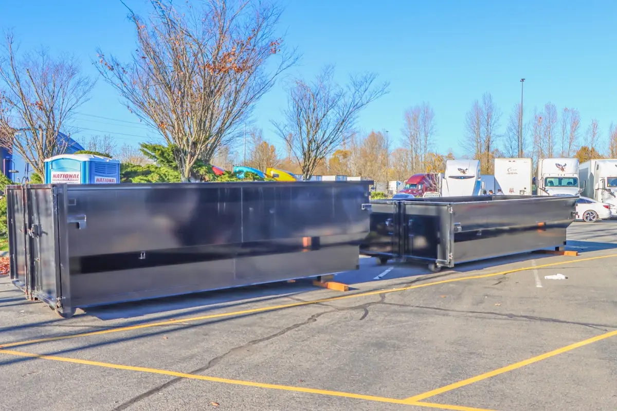 Professional dumpster rental service with roll-off container on residential driveway in Holdenville